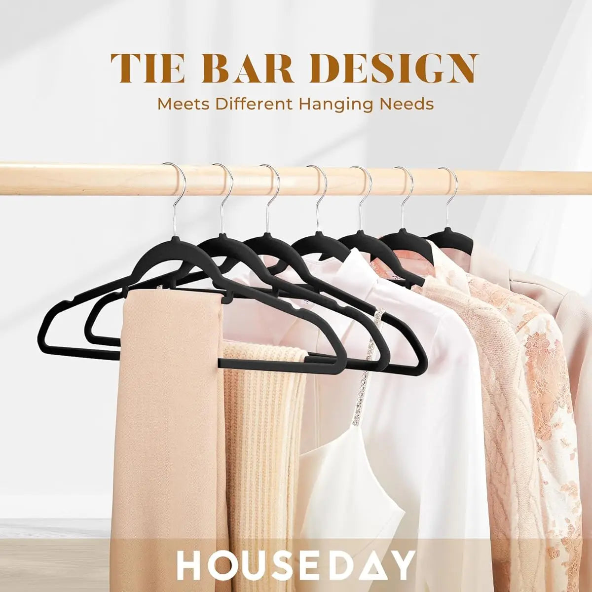 Black tie bar design hangers hanging on a wooden rod with various clothing items.