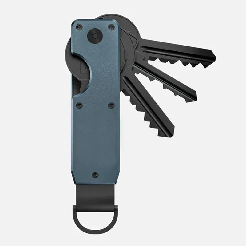 A minimalist aluminum key organizer with a dark gray body and a black key, shown from the side.
