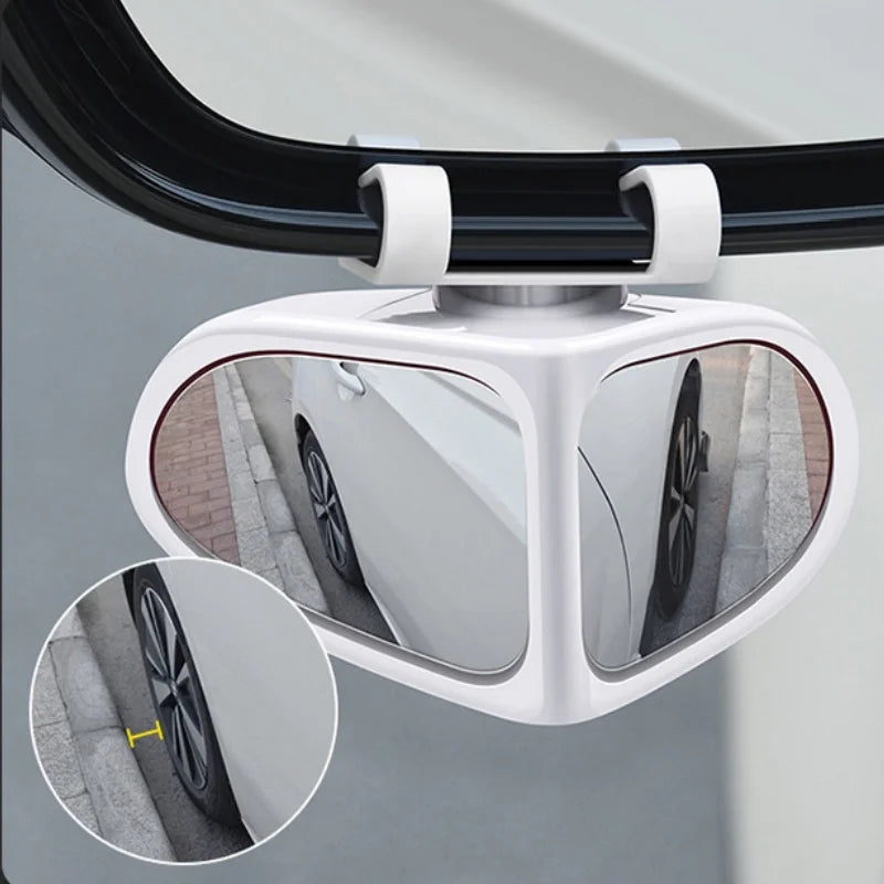 A white adjustable blind spot mirror for a car mounted on a rearview mirror.