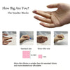 Hand holding a small pink block next to a hand, demonstrating the size difference between standard and micro mini building bl