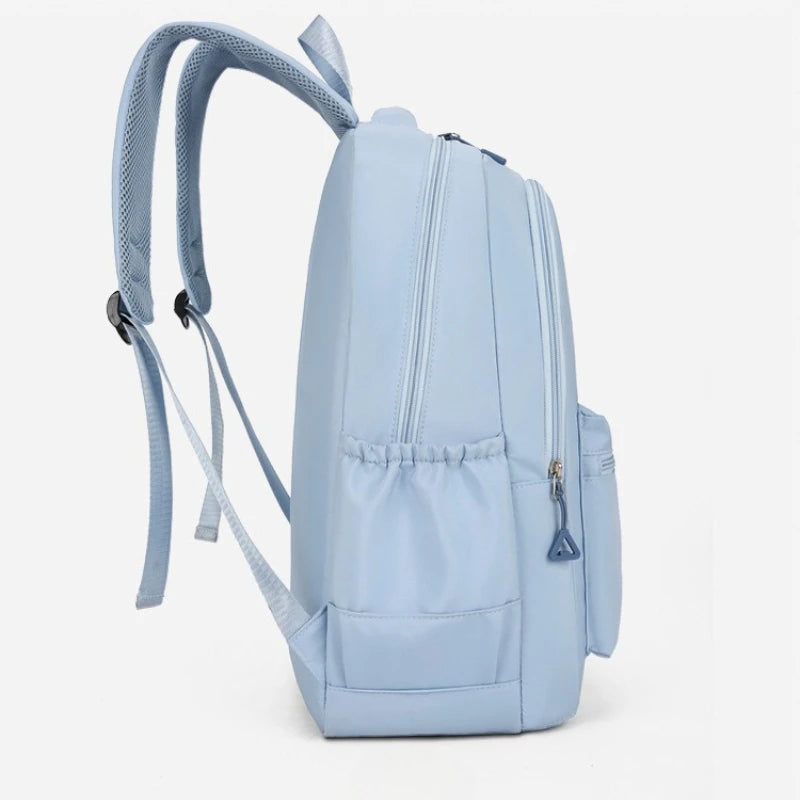 Light blue urban nylon backpack with adjustable straps and zippered compartments