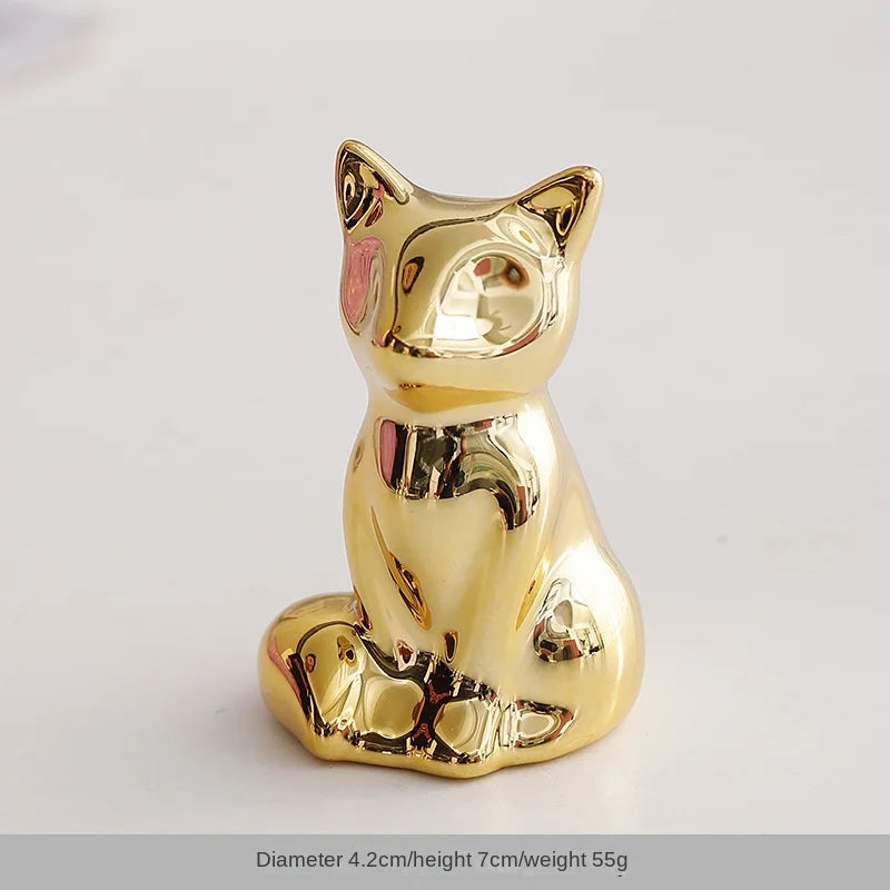 Gold-colored ceramic elephant and rabbit jewelry holder with a squat sitting pose