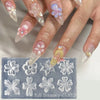 A hand displays floral silicone nail art molds featuring various flower shapes and petals.
