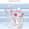 A white and pink interactive dancing robot toy is shown standing on a light blue surface.