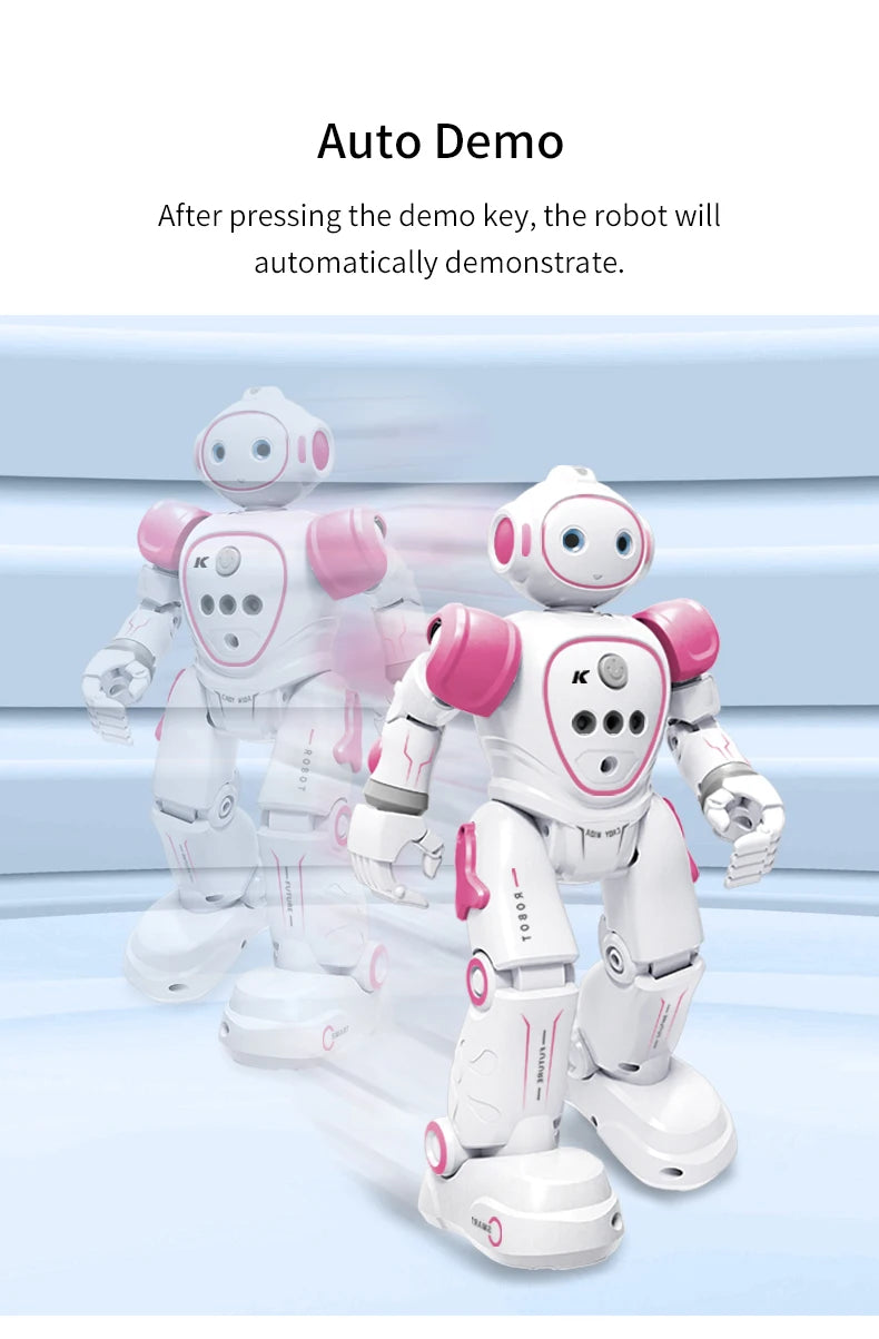 A white and pink interactive dancing robot toy is shown standing on a light blue surface.