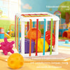 A white Montessori rainbow ball with various textures and shapes for visual and tactile development.