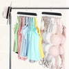 A wooden hanging organizer rack displaying various colorful belts, hats, and accessories on hangers.