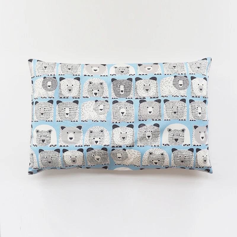 A rectangular pillowcase featuring a repeating pattern of cute, gray and white cartoon bears on a blue background.