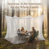 A family is enjoying a meal under a spacious 3x3 meter mesh fly net sanctuary in a forest setting.