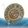 A round, textured leather gauge with a star pattern is shown partially submerged in water.
