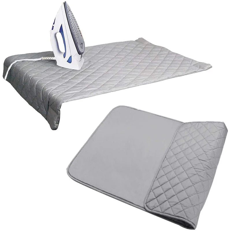 A heat-resistant portable ironing mat with a white iron and ironing cloth shown on a surface.