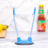 A blue adjustable bag holder rack for kitchen storage and drying sits on a white marble surface.