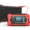 An orange battery charger with an LCD display and cable is shown next to a black battery.