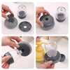 A set of black press dish brushes with built-in soap dispensers shown in various angles.