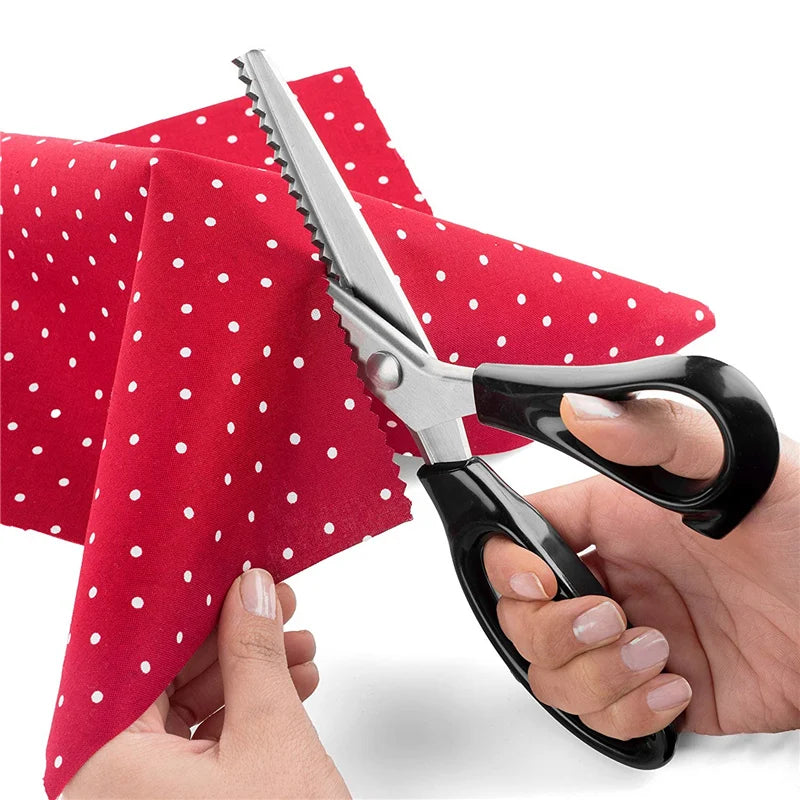 A pair of professional pinking shears is shown being used to cut fabric, with a red polka-dot cloth in the background.