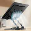 A black 360° rotating carbon steel tablet stand is shown on a wooden desk.