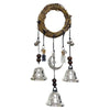 A rustic witch bells door hanger wind chime made of woven branches and hanging metal bells.