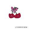Pink and red embroidered letter patches featuring a bow and two hearts on green stems