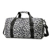A black and white leopard print travel tote bag with handles and a shoe compartment.