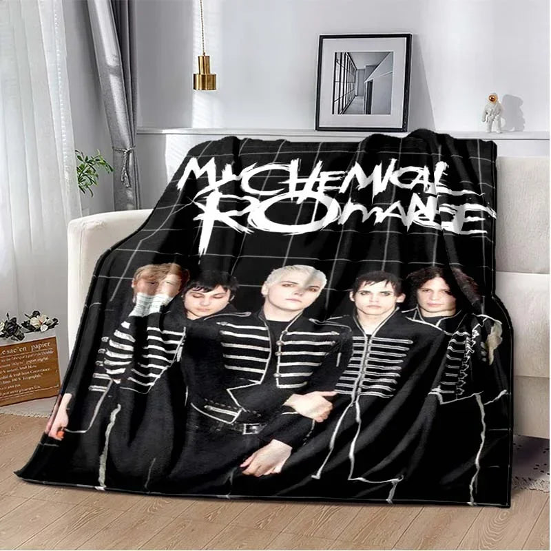 A black and white graphic blanket featuring the My Chemical Romance band members.