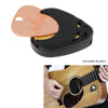 A pink and black adhesive guitar pick holder with a cutout for picks, shown next to an acoustic guitar.