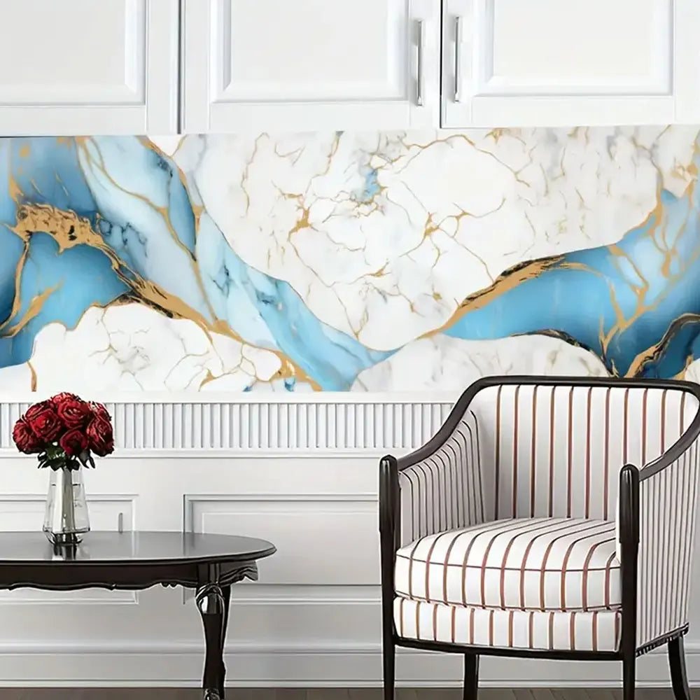 A dining setting featuring a striped chair against a marble-patterned wall and white cabinetry.