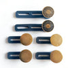 Six brass and dark blue no-sew button waist extenders displayed on a white background.