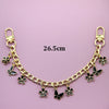 Gold chain necklace with black butterfly and flower charms, measuring 26.5cm.