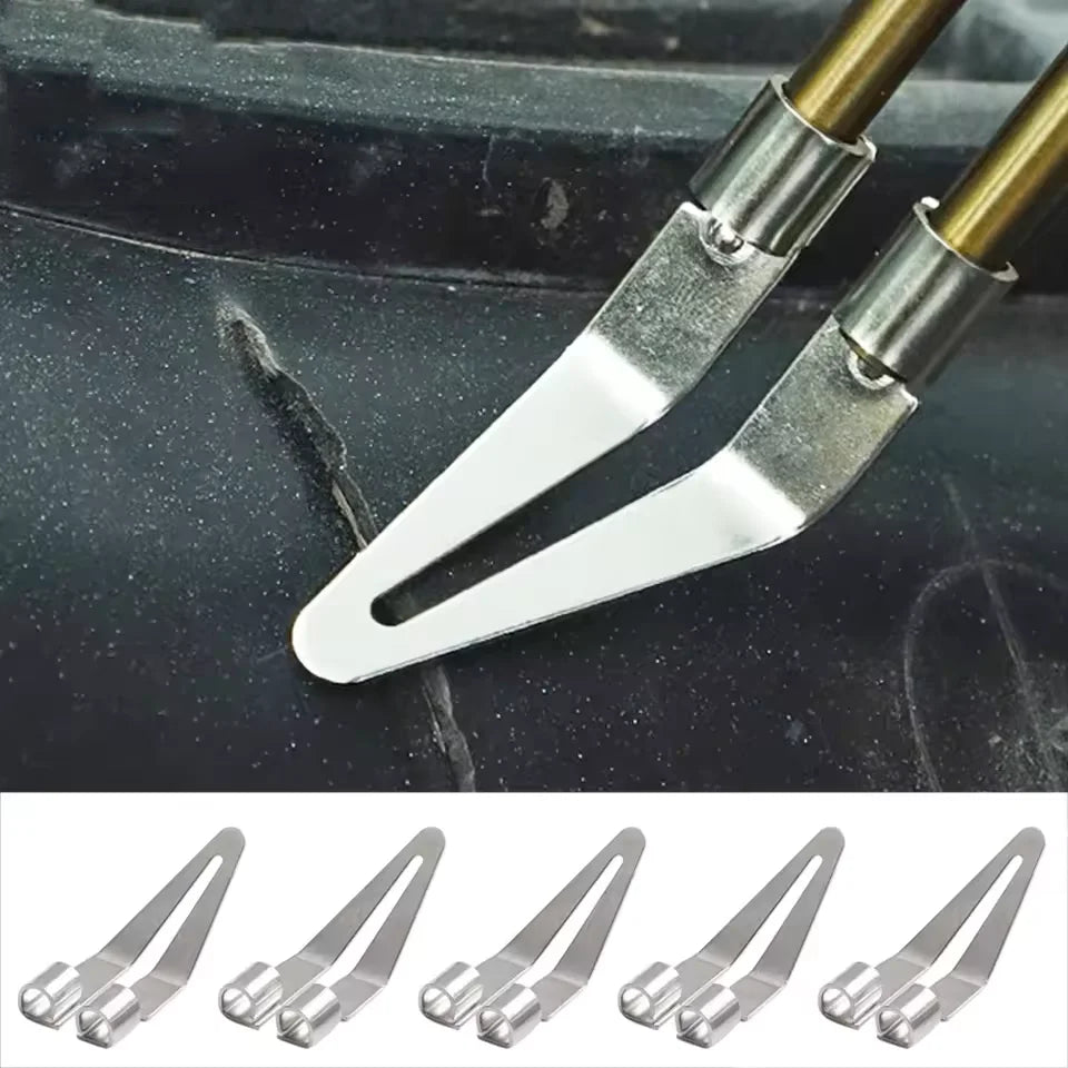 A pair of silver plastic welding repair pliers with smooth tips resting on a dark surface.