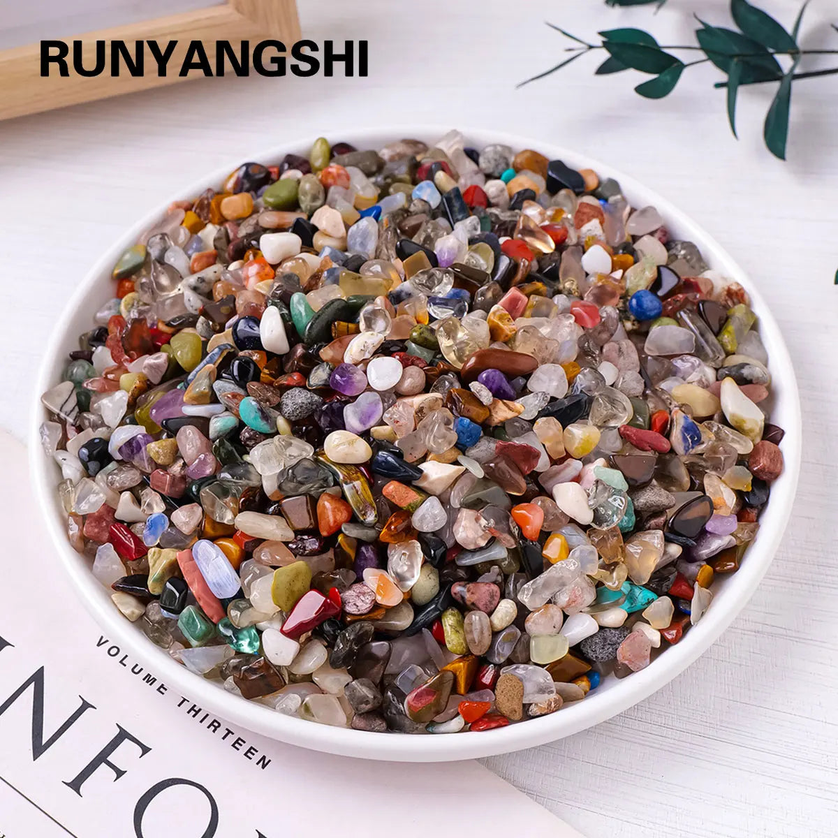A bowl filled with mixed natural crystal gravel stones and gemstone chips for home decor and meditation.