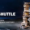 A detailed wooden space shuttle model kit with a launch simulator displayed against a dark, starry background.
