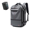 A gray expandable travel laptop backpack with a separate vacuum compression unit.