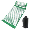 A green acupressure mat and pillow set with white dots for pain relief and relaxation.