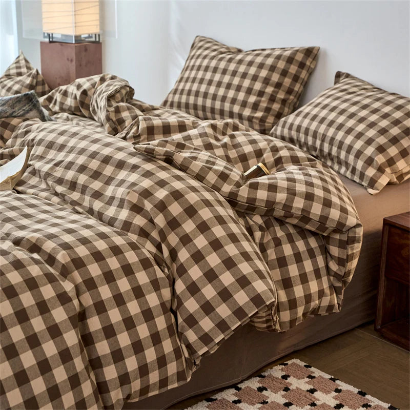 A plaid duvet cover in brown and beige tones with a checkered pattern on a bed.