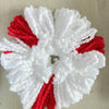 A white and red floral wreath made of fluffy white and red yarn or fiber for mop pad replacements.
