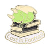 Enamel pin featuring a green unicorn head resting on a stack of gold-edged books with the text Lost in Fantasy