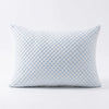 A light blue textured memory foam pillow with a quilted pattern.