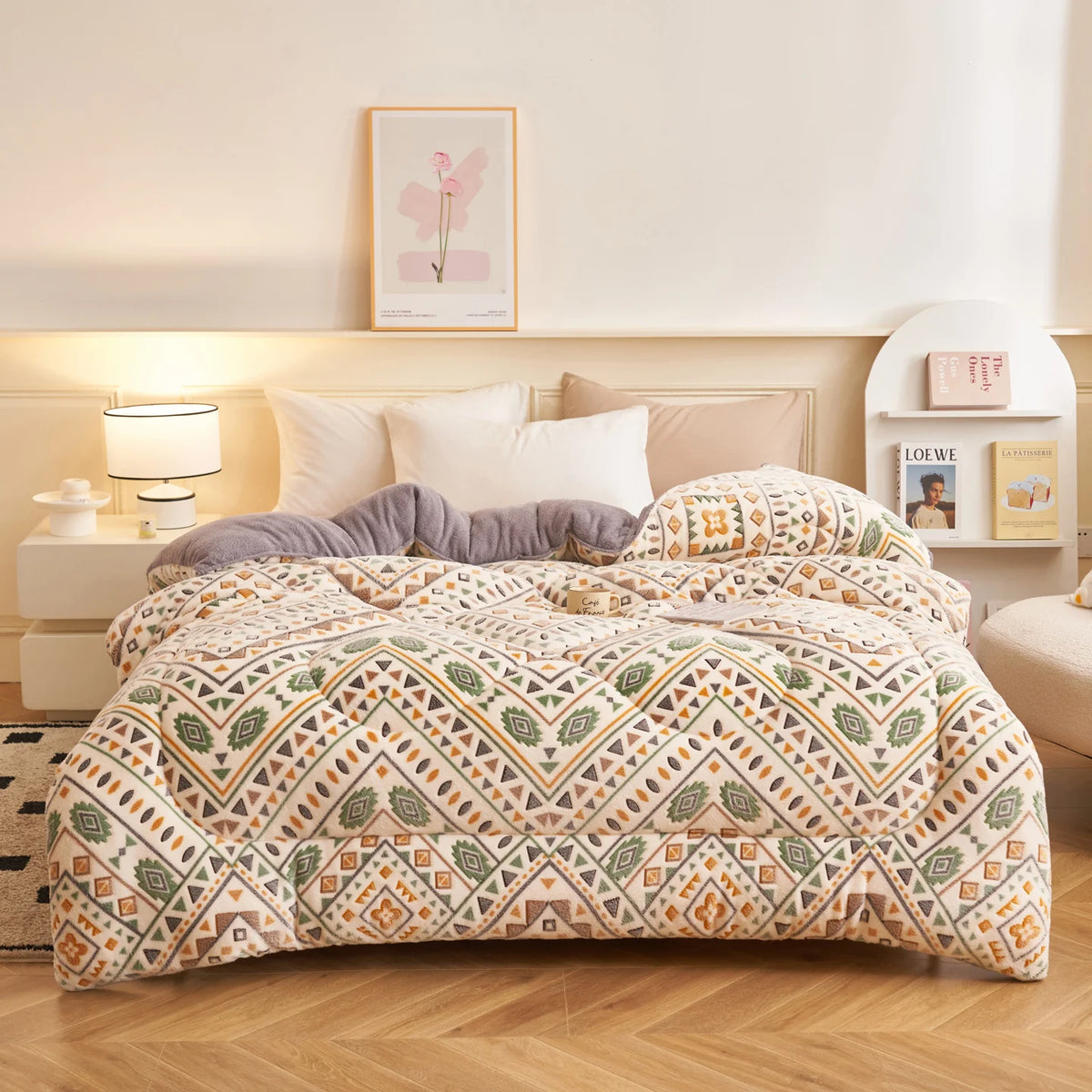 A beige and green patterned plush throw blanket is displayed on a bed with white linens and wooden furniture.
