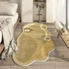 A beige irregular area rug with a subtle floral pattern is placed on a light wood floor next to a bed.