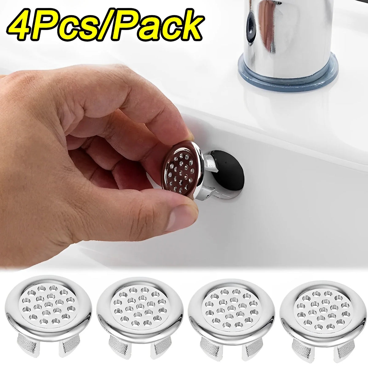 A hand holds a set of chrome sink overflow covers, showing four individual silicone or plastic covers.