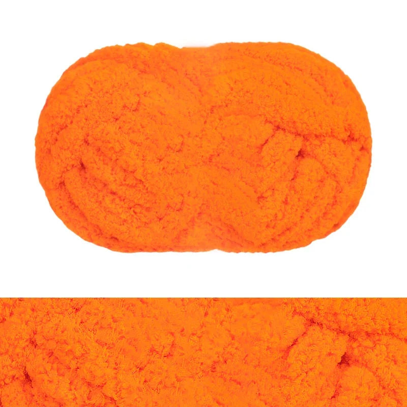 A ball of bright orange chunky chenille yarn for hand knitting and crochet