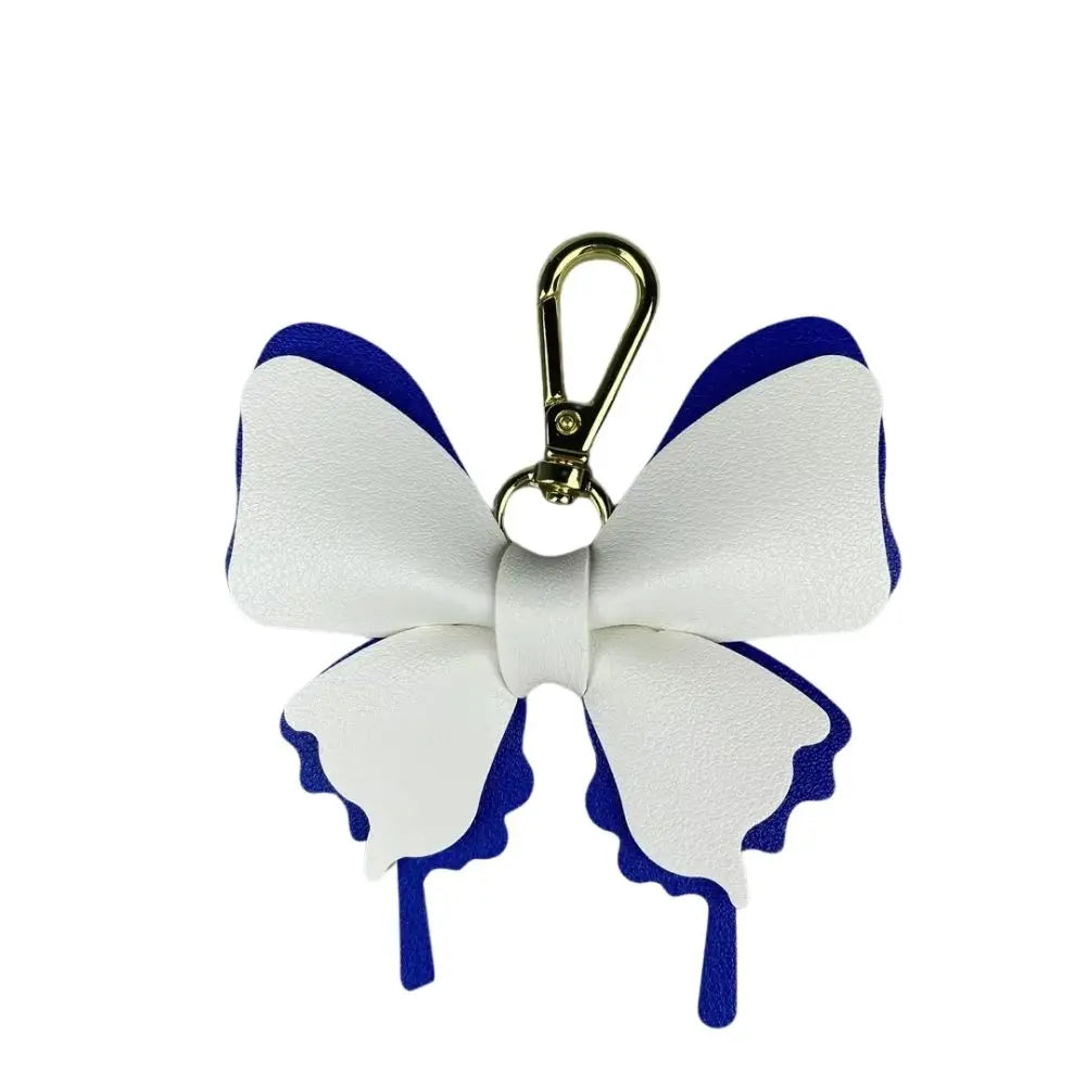 A white and blue PU leather butterfly bag charm with a gold-colored loop.