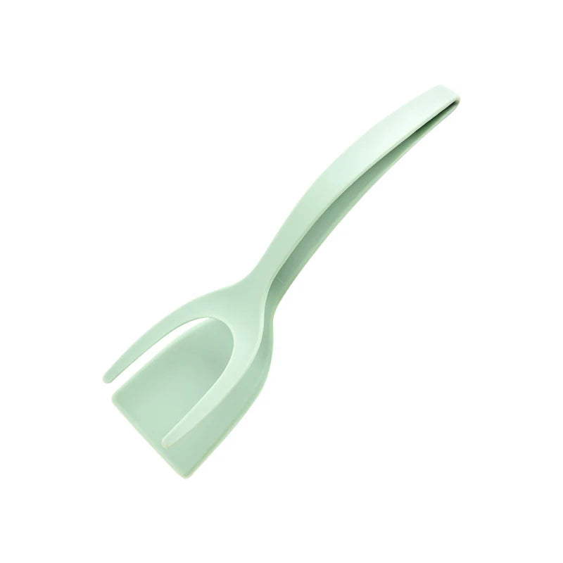 A light mint green 2-in-1 grip and flip spatula tool.