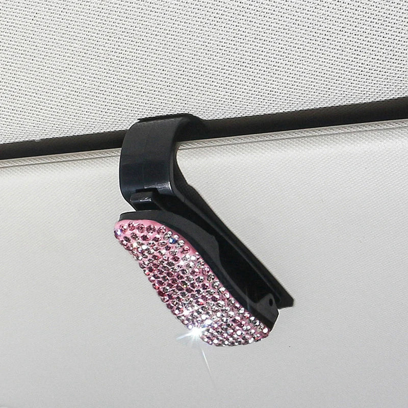 Black clip with pink rhinestone embellishments for a car sun visor