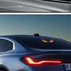 Close-up of a dark blue car with a red LED demon eye decal on the hood and a similar light strip on the front fender.