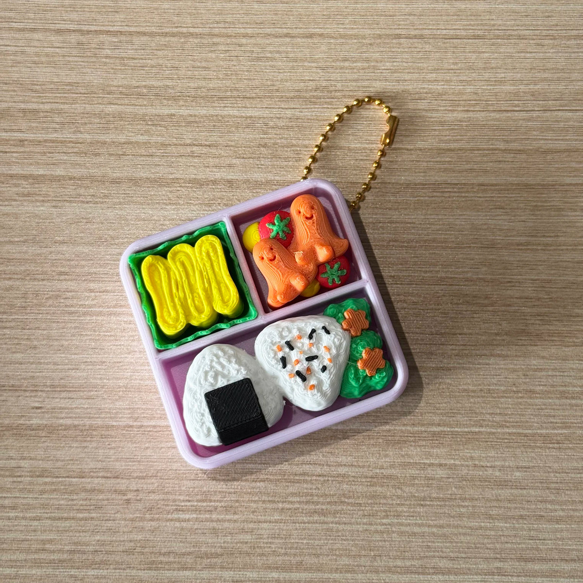 A pink plastic container holds various orange and green cartoon-themed fidget cakes and a white cake.