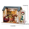 A miniature wooden dollhouse building kit featuring a cozy interior with furniture and holiday decorations.