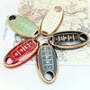 A collection of five gold and green soft TPU car key fobs with various button layouts displayed on a textured paper backgroun