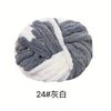 A ball of chunky acrylic yarn in gray and white stripes for knitting and crochet