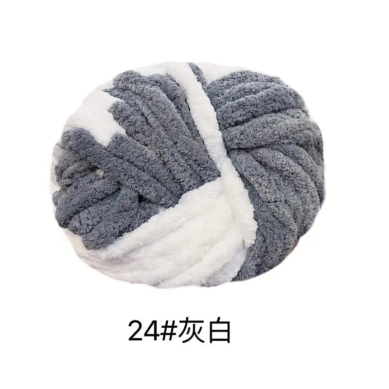 A ball of chunky acrylic yarn in gray and white stripes for knitting and crochet